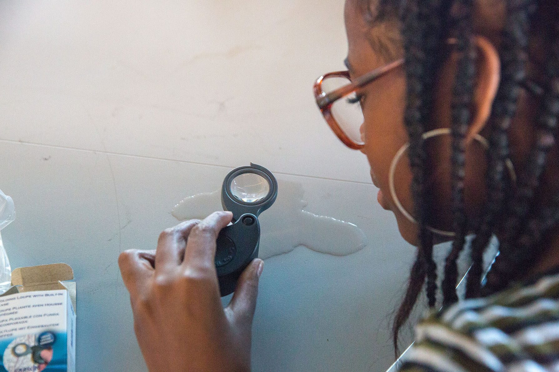 Girl Examining Water Through a Magnifying Glass